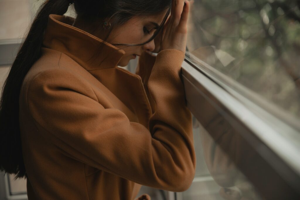 a woman thinking about her self sabotaging behaviors