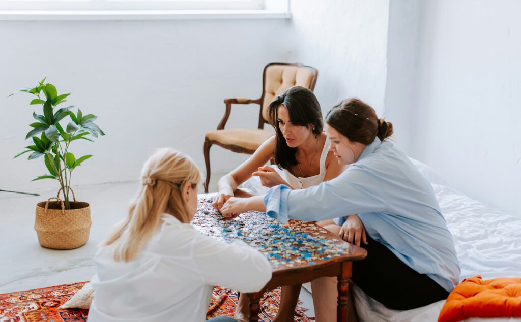 women doing puzzle