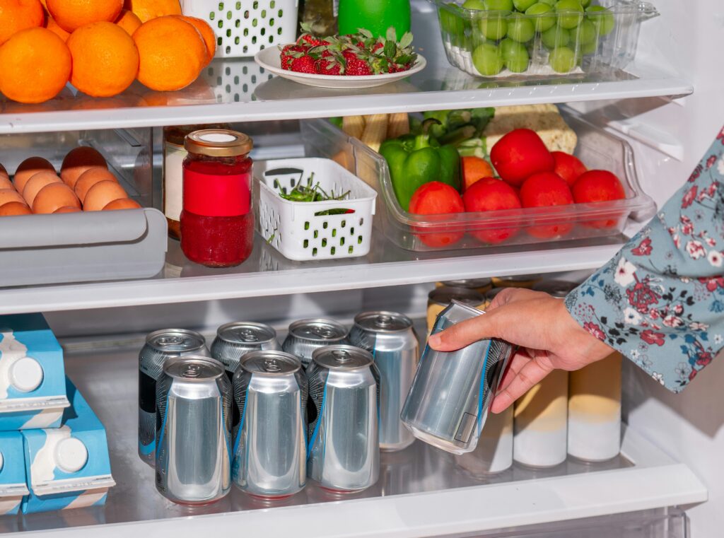 a woman doing fridge restock