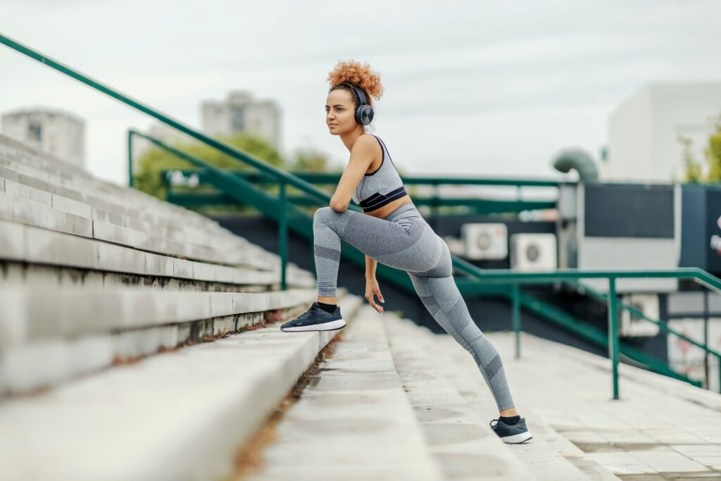 a woman working out on the stairs outside