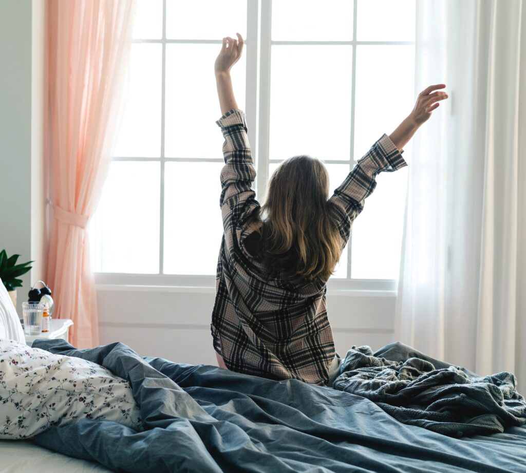 a woman next to the window in the morning