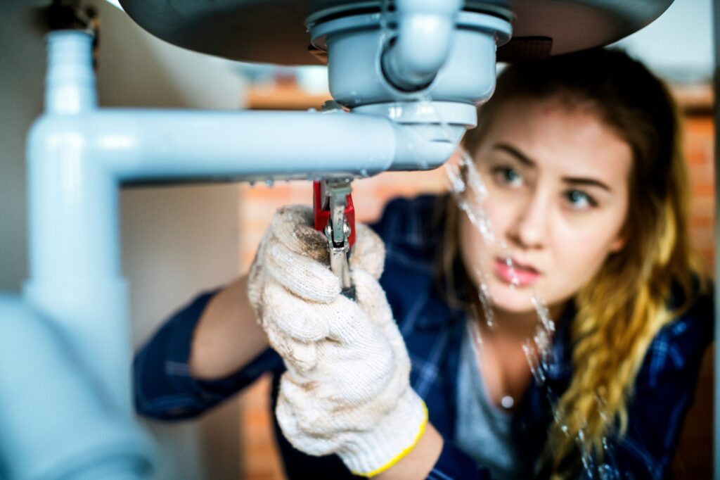 a woman doing plumbing