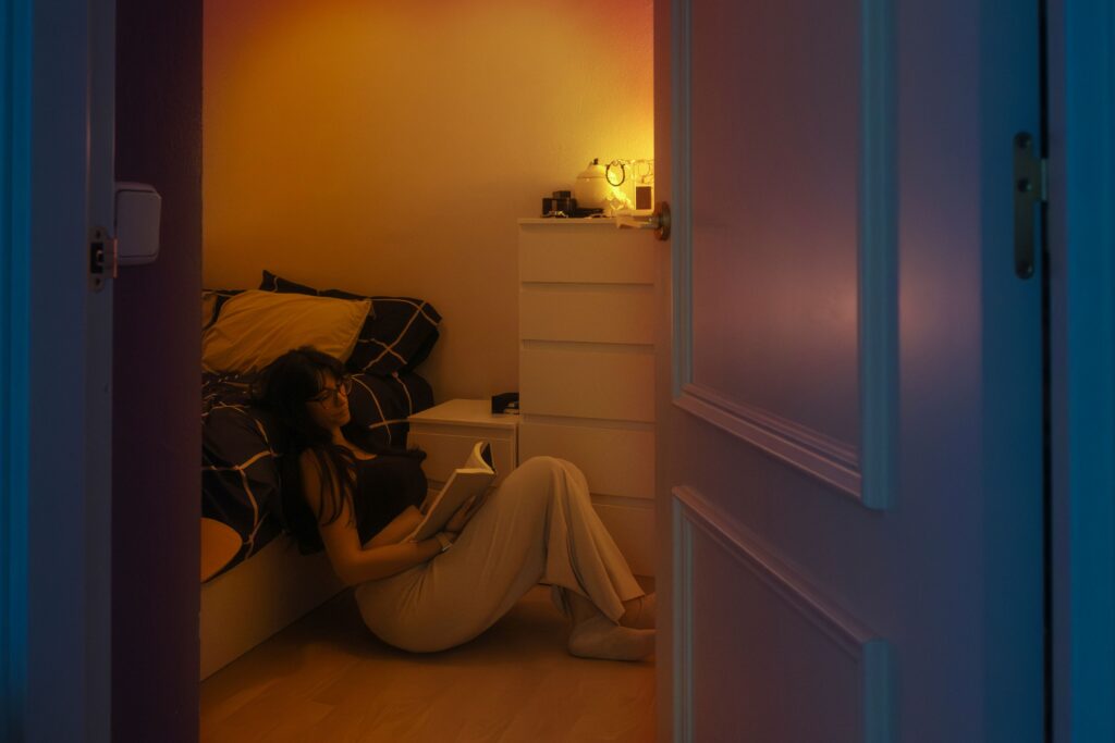 a woman next to her bed